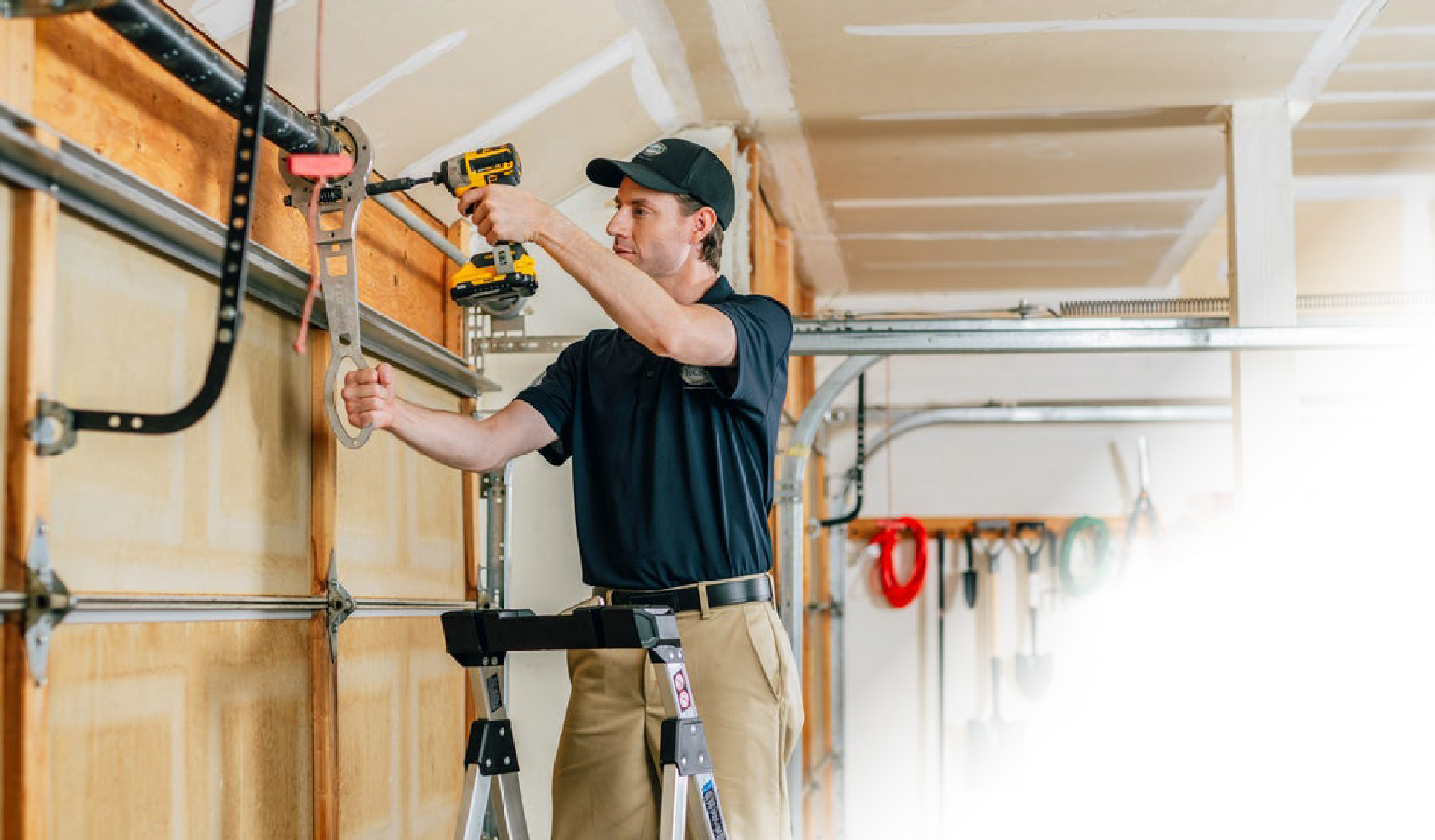 image of a Precision Door Service technician fixing a garage door opener.